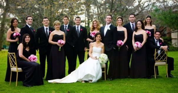  a full cast of wedding party charmers mirroring them in black and white 